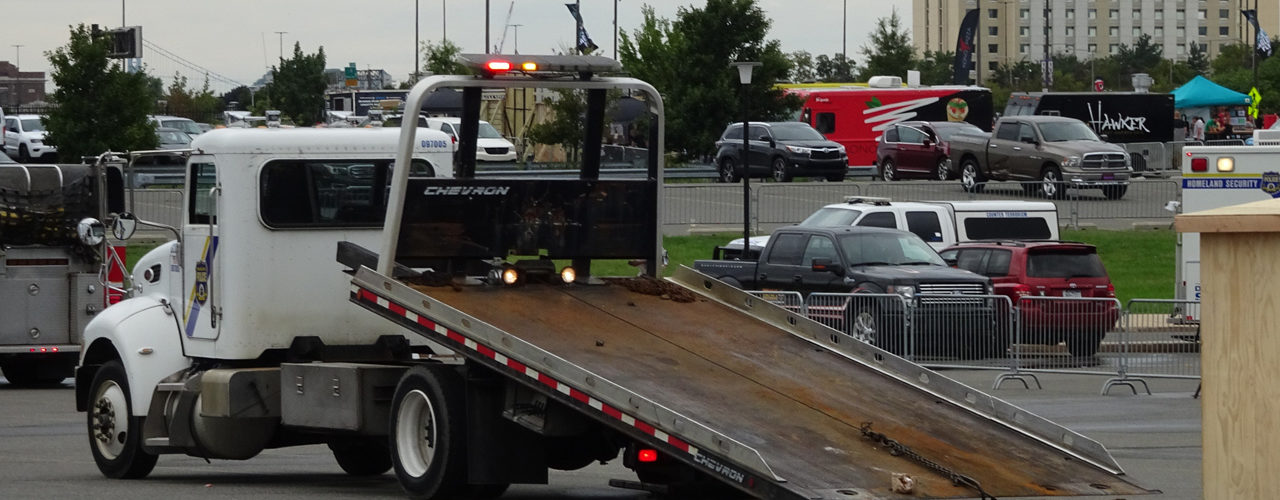 Flatbed Tow Truck With Bed Hydraulics Engaged