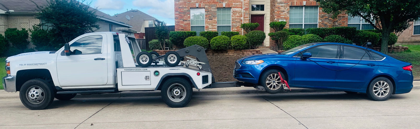 Wheel Lift Tow Truck In NC Hauling Blue Car