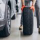 car mechanic rotating tires for client