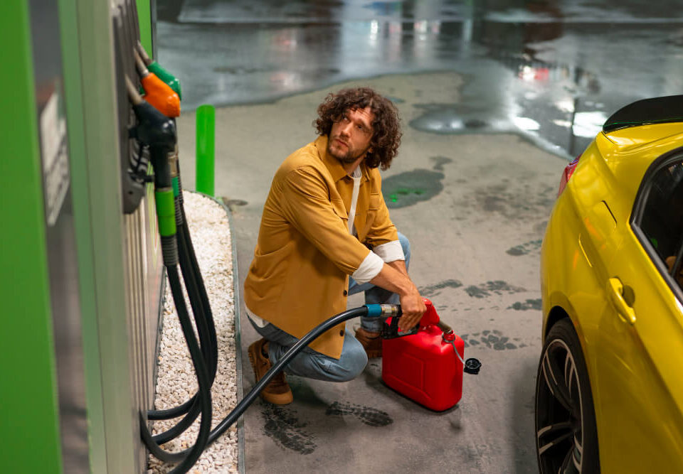 man putting fuel in a gas tank