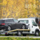 black car on a flatbed tow truick