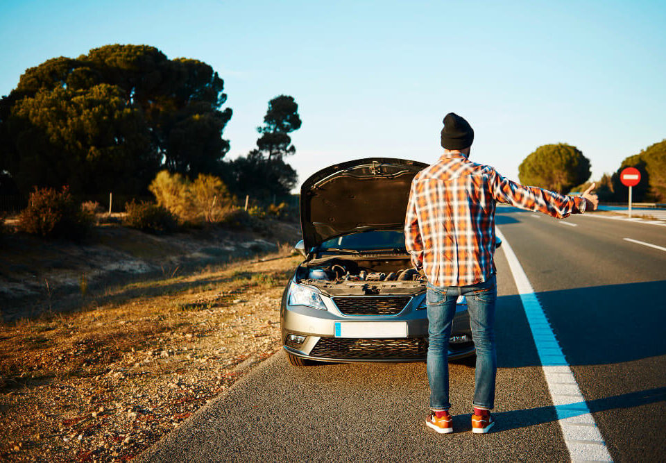man with a disabled car on the side of the road