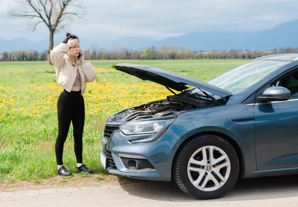 woman with her car broken down and away from home.